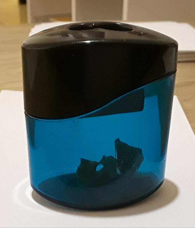 Photograph of pencil sharpener with container.