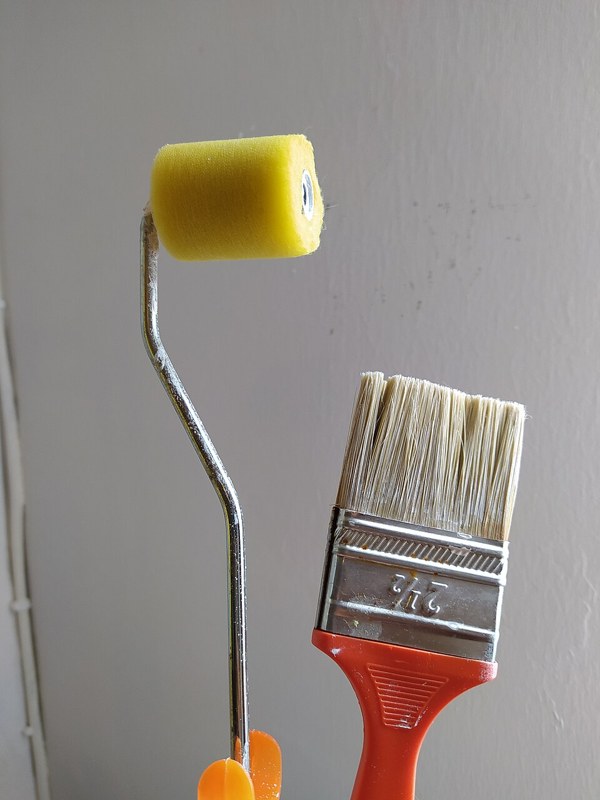 Photograph of paintbrush and roller.