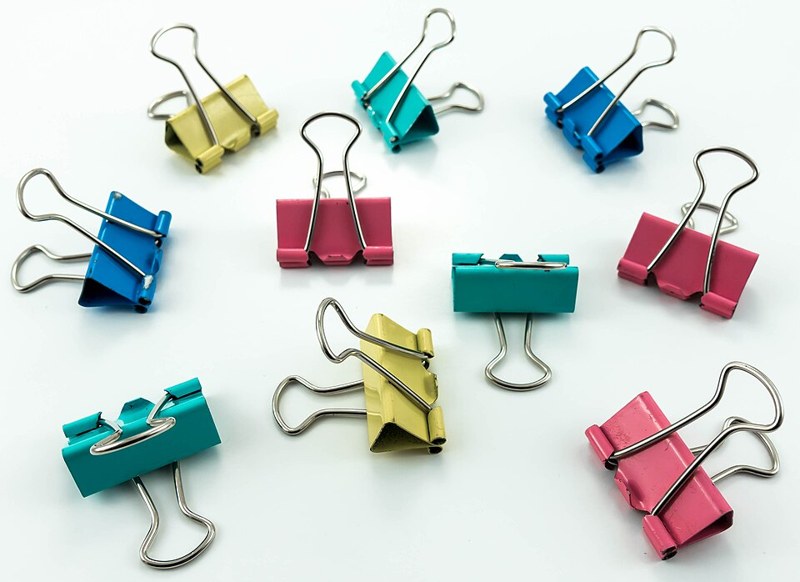 Photograph of colourful binder clips.