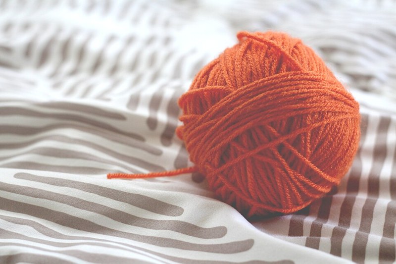 Photograph of orange yarn ball.