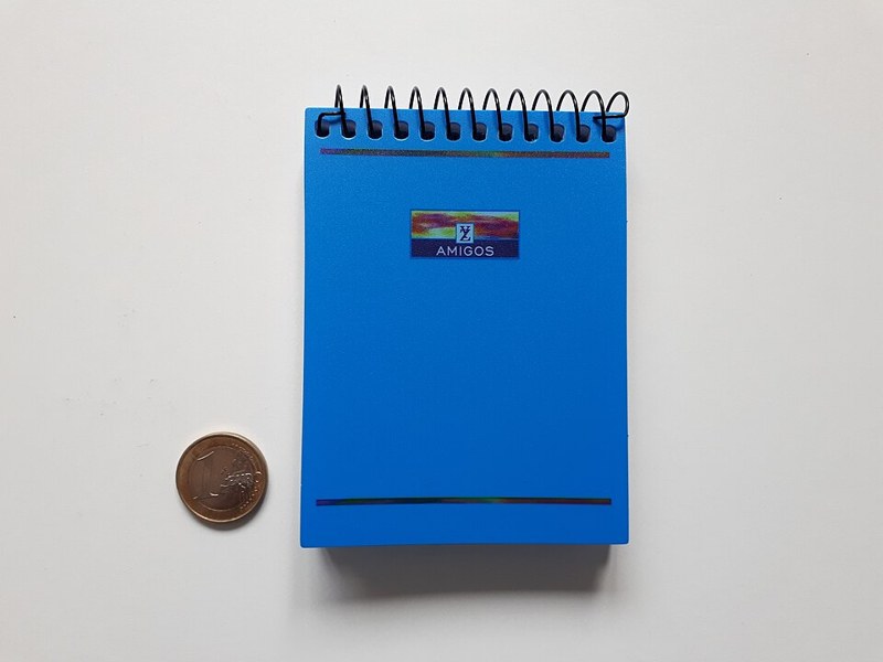 Photograph of small blue notepad.
