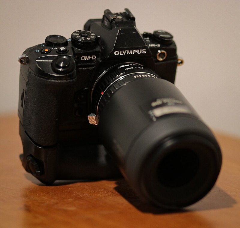 Photograph of mirrorless camera with adapted lens.